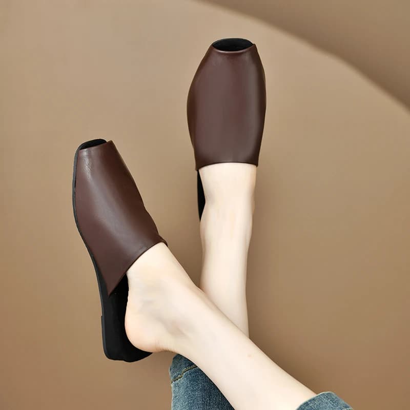 Mule feminina marrom de couro com bico coberto e solado preto, design moderno e confortável