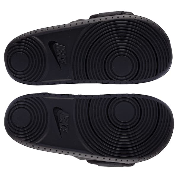 Detalhe da sola da Nike Offcourt Adjust Slide Adulto em preto, com design em relevo.