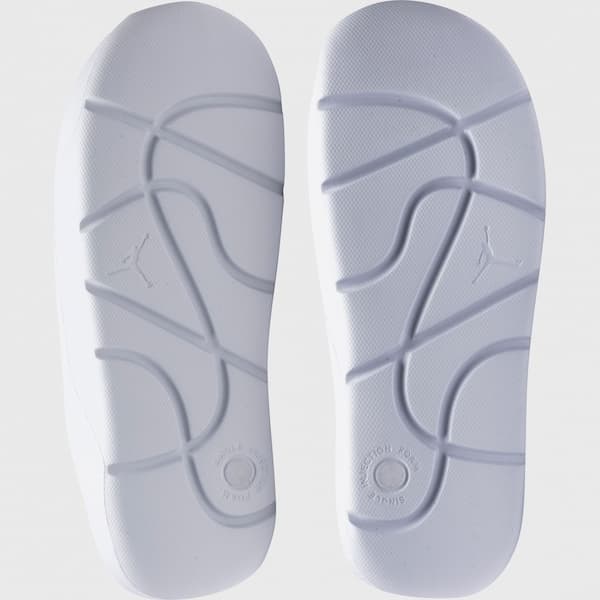 Sola da sandália Nike Jordan Post Slide texturizada branca com design ventilado.
