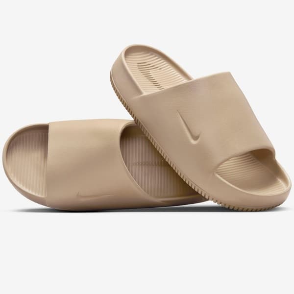 Par de sandálias de slide Nike Calm Essential em bege, com sola texturizada.