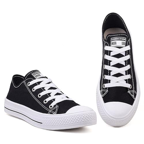 Par de ténis casual feminino cano baixo preto e branco, etiqueta Conecção.