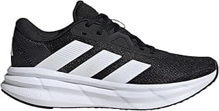 Tênis de corrida Adidas Galaxy 7 feminino, preto e branco, contra fundo neutro